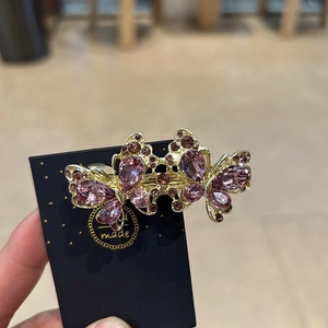 Eleganter Doppel-Schmetterling-Haarclip mit rosa-lila Kristallen auf Goldbasis