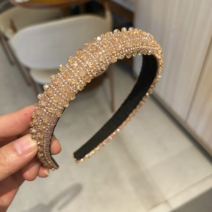 Close-up of luxury champagne crystal beads on a stylish wide headband for women