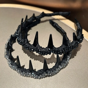 Detail of gothic black headband with sharp spikes and sparkling crystal beads decoration