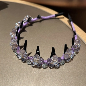 Detailed macro of crystal beads and comb teeth on light purple handmade headband