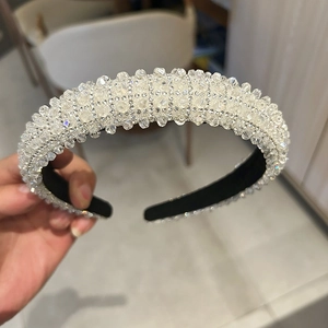Detailed close-up of hand-set crystal rhinestones and anti-slip black fabric on a luxury headband