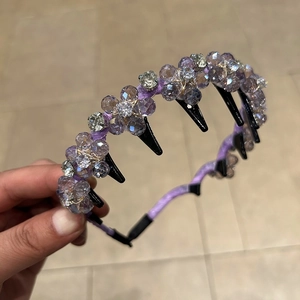 Detailed macro view of purple crystal flower headband with double-layered hair clips