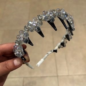 Detail of handcrafted crystal flower headband with integrated hair comb teeth