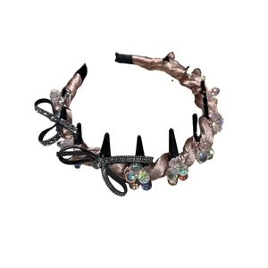 Champagne pink satin headband with double-layered rhinestones and crystal bow details