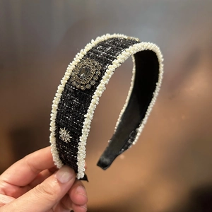 Detail of tweed headband with pearls and a large centered grey crystal accent