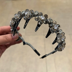 Close-up of luxury hand-woven headband featuring grey crystals and detailed insert comb teeth