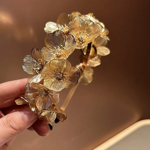 Elegant gold ginkgo leaf hair hoop with sparkling rhinestones for bridal hairstyle