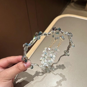 Detail of French wavy headband featuring colorful crystal rhinestones on silk fabric