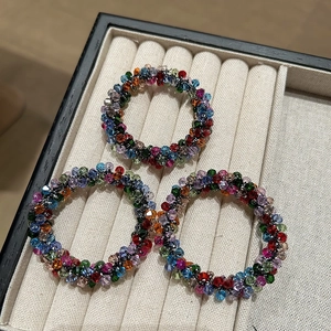 Three-pack colorful crystal beaded elastic hair ties on beige velvet display tray