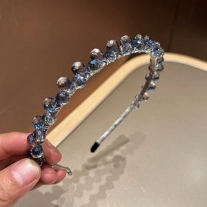 Vue détaillée des perles de cristal dégradé bleu-gris sur un serre-tête fin en métal