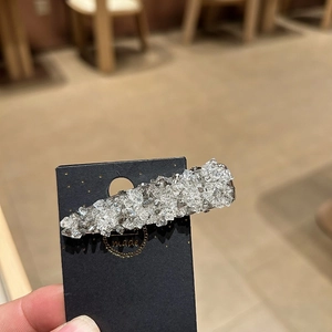 Elegant sparkling rhinestone hair clip on display card with a premium textured finish