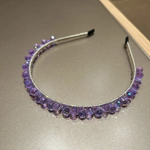 Detailed view of handmade headband with luxury faceted purple crystal beads and silver wire