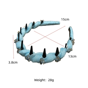 Detail view of light blue fabric headband with crystal accents and twisted mesh texture