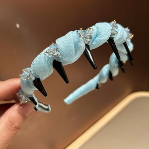 Light blue pleated fabric headband with black punk spikes and crystal beads