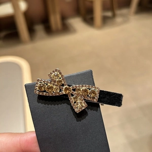 Sparkling black velvet bow hair clip with amber rhinestones and crystal outlines for women