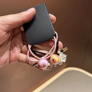 Close-up of elastic hair ties with faceted crystal beads and gold star pendants