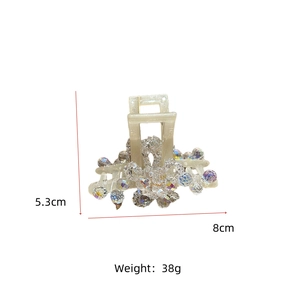 Detail view of cream crystal hair claw clip showing 8cm length and 38g weight measurements
