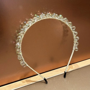 Close-up of handmade crystal headband with multifaceted beads and polished metal frame