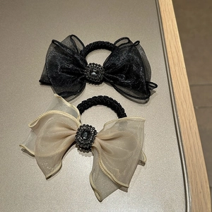 Close-up of mesh bow hair ties with sparkling rhinestones and elastic bands