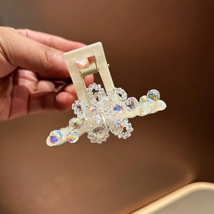 Luxurious crystal hair claw clip with floral resin design and shimmering gemstones