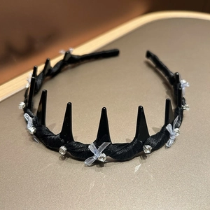 Detail of black toothed headband with blue mesh bows and sparkling rhinestones