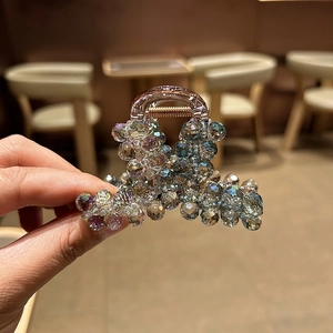 Détail d'une pince à cheveux perlée avec cristaux irisés et dégradé pour femmes