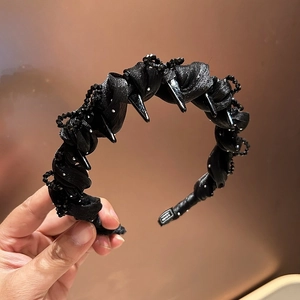 Gothic beaded headband with black spikes and silk texture for luxury styling