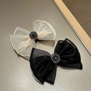 Detail of organza bow hair clips with vintage dark gemstones and rhinestone accents