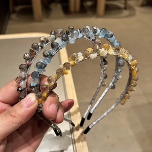 Close-up of three handmade beaded headbands with crystal glass beads and non-slip ends