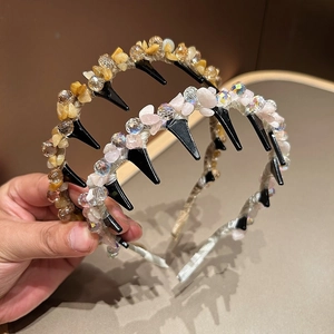 Detailed close-up of handmade beaded headbands with colorful stones and crystals