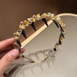 Detail showing crystal-encrusted headband with hand-woven stones and anti-slip teeth