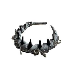 Silver silk headband with black punk spikes and crystal beads on a white background