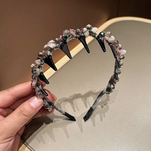 Detail of handmade headband with woven colorful crystal stones and anti-slip teeth design