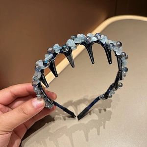 Detailed close-up of blue crystal stone headband with toothed hair clips for secure styling