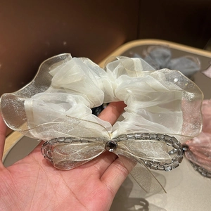 Elegant organza scrunchie with lace bow and crystal bead details for hair styling