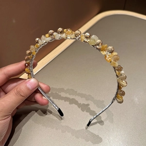 Detail of handcrafted silver headband featuring faceted amber beads and natural stones