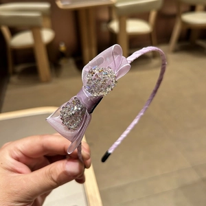 Close-up of light purple organza bow headband with sparkling crystals for elegant styling