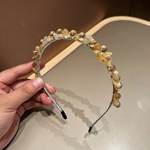 Detail of handmade crystal beaded headband with amber stones and silver wire wrapping