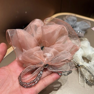 Elegant pink mesh lace scrunchie featuring a crystal bow and beaded details for hair