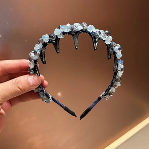 Detail of beaded headband featuring blue crystals and integrated hair comb teeth