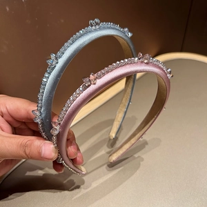 Detail of handcrafted blue and pink crystal headbands with elegant satin finish