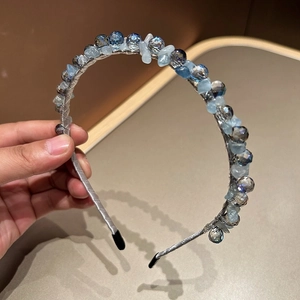 Detail of handcrafted beaded headband with dark blue crystals and light blue stone beads