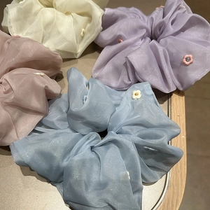 Elegant organza hair scrunchies with floral embroidery in pastel blue and lilac colors