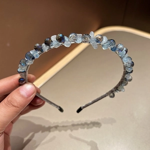 Detailed view of handcrafted blue crystal beads and multifaceted rhinestones on headband