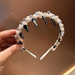Handmade hairband with pink stones and crystals on white woven fabric with inner comb