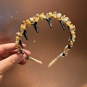 Detail shot of champagne ribbon headband with yellow stones and crystal beads