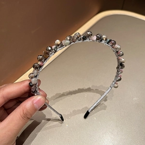 Close-up of handmade beaded headband with crystals and wire-wrapped floral details