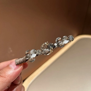 Elegant crystal hair clip with brownish rhinestones and silk wrap on a duckbill base