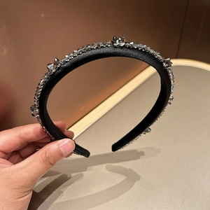 Detailed close-up of crystal butterfly beads on black velvet headband for women