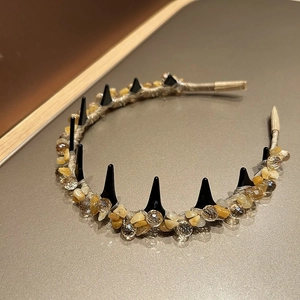 Detailed macro view of handmade crystal beads and stone weaving on this stylish headband